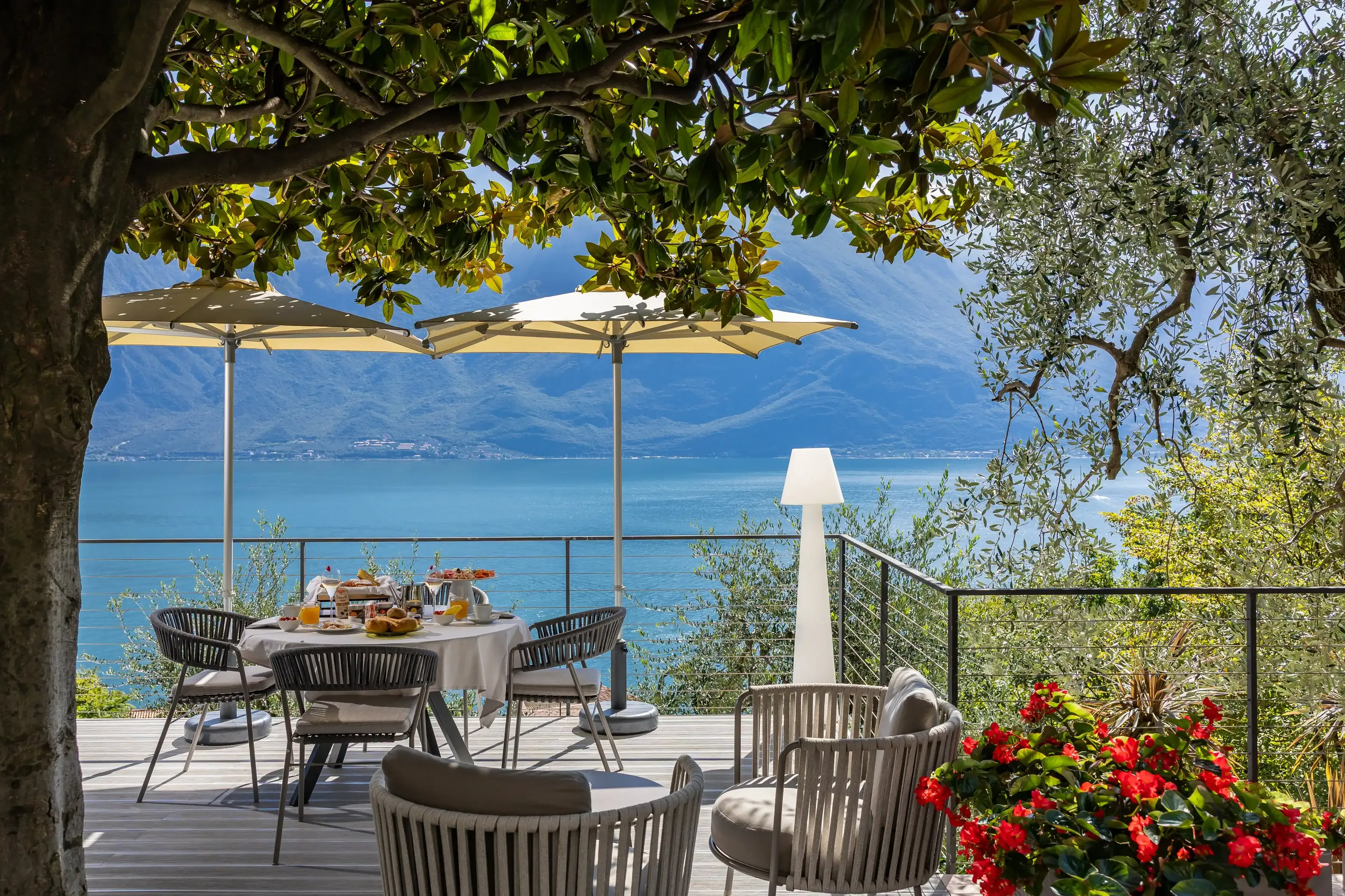 Outdoor breakfast on a terrace overlooking lake and mountains